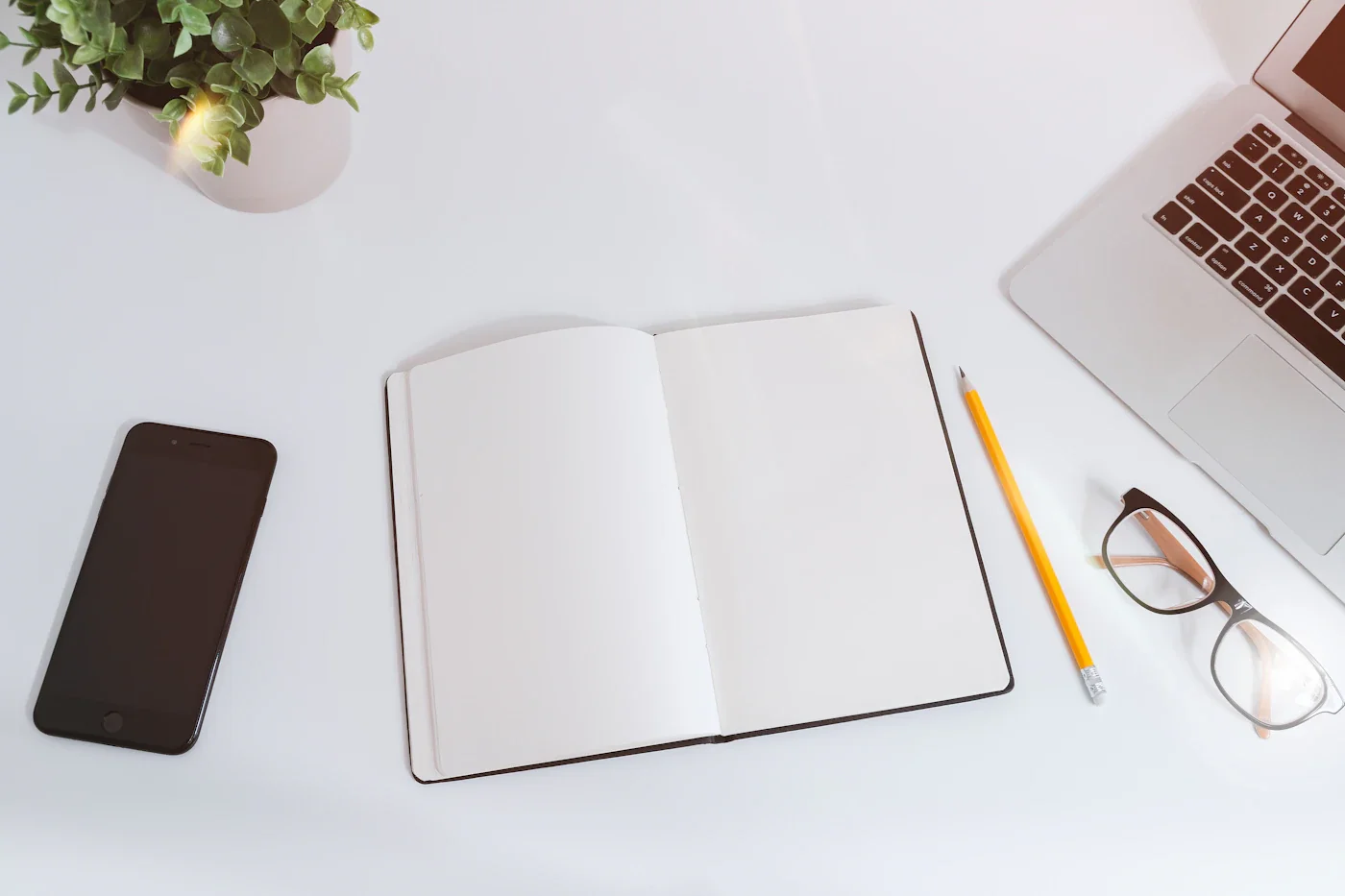 Licensed photograph of a notebook and laptop used as a planning illustration